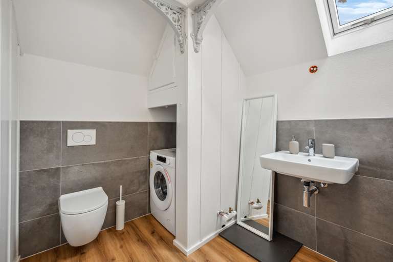 Attic Apartment — bathroom with washing machine